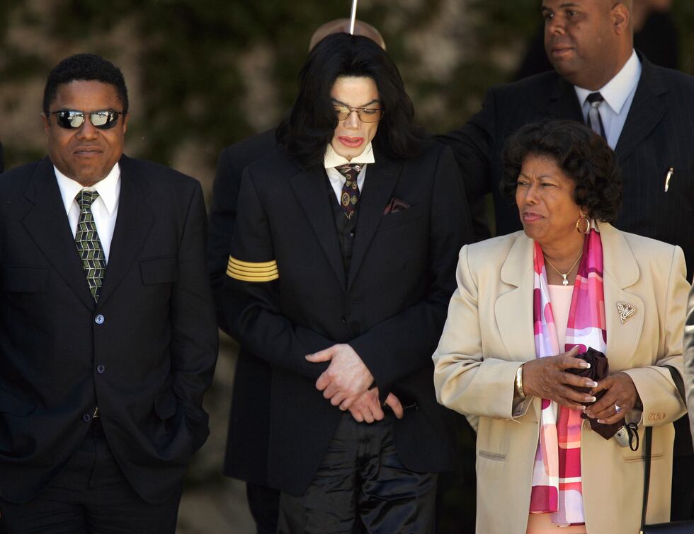 FILE - Pop star Michael Jackson, center, his mother Katherine Jackson, right, and brother Tito...