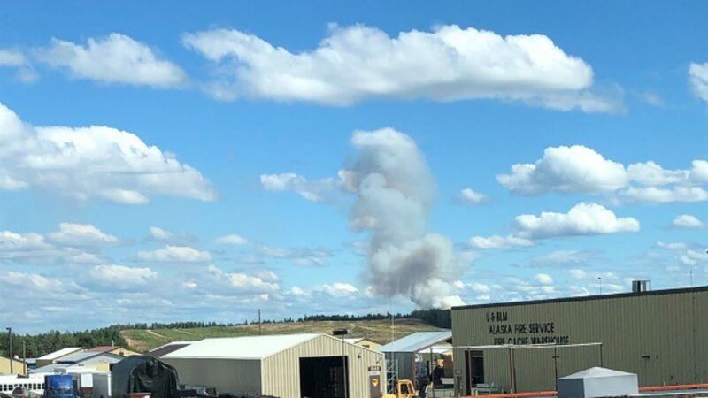 A smoke column from the Brock Road Fire is seen behind the BLM Alaska Fire Service warehouse...